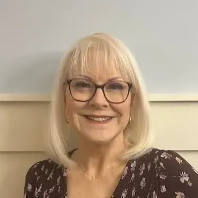 Eye Doctor Brainerd Rd Chattanooga TN Cindy Meet The Team Cindy smiling while wearing glasses.