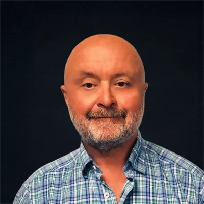 Dr. Bencho smiling in a blue button up shirt.
