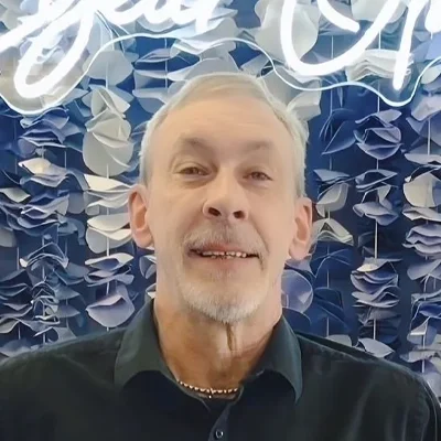 Jeff smiling while wearing a black shirt.